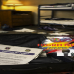 Abandoned luggage with fake football contract in a Spanish hostel room showing immigration fraud