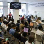 Crowded foreign national office in Spain with applicants waiting for the process of regularisation of migrants.