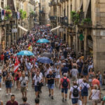 Overtourism in Spain as tourists crowd a historic street in Barcelona