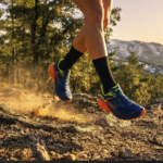 Runner wearing professional sports gear from Bikila on a scenic mountain trail in Spain.