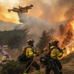 Spanish firefighters battle a large wildfire near Madrid as flames spread through forest areas.