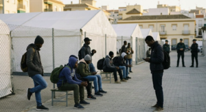 Sub-Saharan migrants wait at a reception center in Ceuta