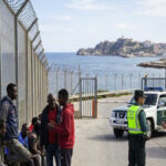 Ceuta migration crisis with migrants and Spanish security forces at the border