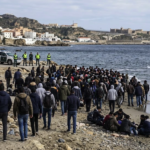 Migrants gathered on a beach in Ceuta during the migration crisis