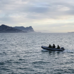 Small boat sailing across the Strait of Gibraltar between Ceuta and mainland Spain