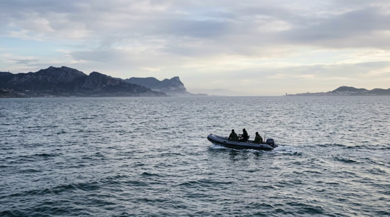 Small boat sailing across the Strait of Gibraltar between Ceuta and mainland Spain
