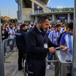 Security guard working at a football stadium entrance in Malaga