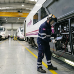 Railway maintenance worker inspecting a Renfe train in Spain