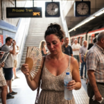 Passengers try to cool down during a heatwave in Madrid