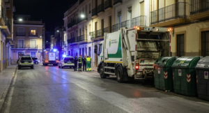 Garbage collection truck beside waste containers in Cartagena after a fatal incident